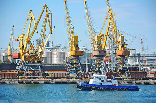 istock Tugboat and port cargo crane 622914180