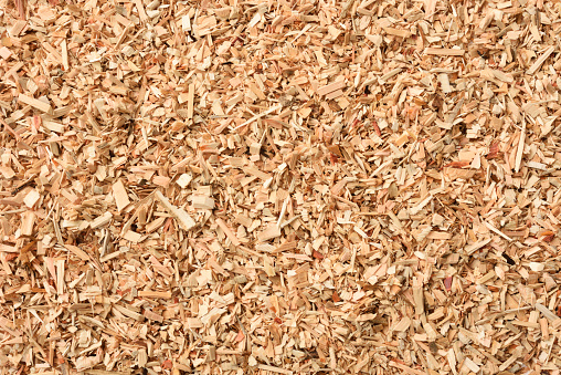 Wooden chips as background, top view. Wood shavings for smoking meat and fish. Wood texture.