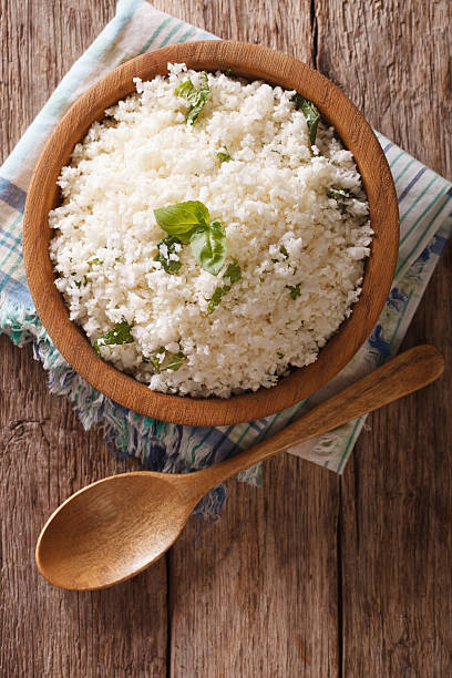 istock Cauliflower rice with basil in bowl close-up. Vertical top view 622915032