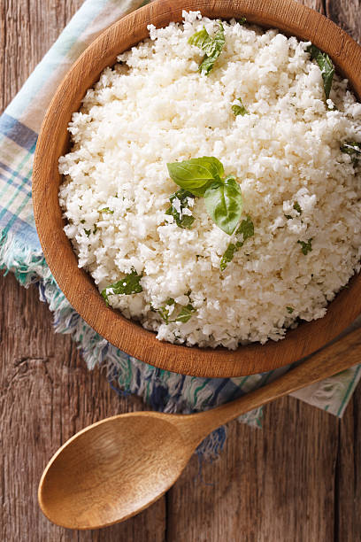 istock Paleo Food: Cauliflower rice with herbs close-up. Vertical top view 622915370