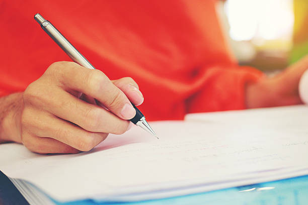 istock Monk's Hand writing in a book with the pencil 622915572