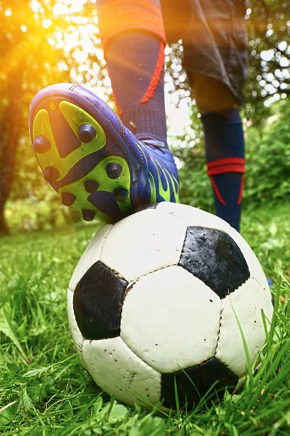 istock foot with footbal boots on the ball 622917986
