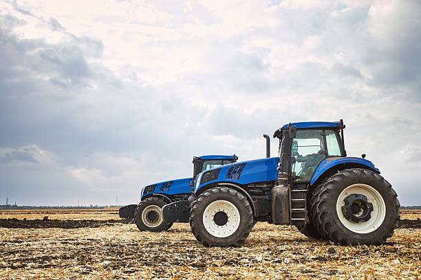 istock Two tractor cultivating the land 622919888