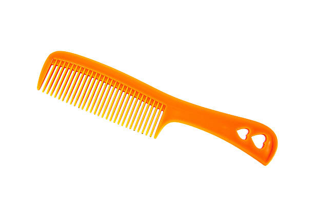 Orange comb with heart handle style isolated on white background