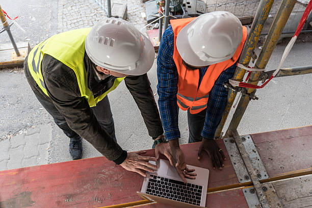 istock Two civil engineers at work with laptop. View from above 622921248
