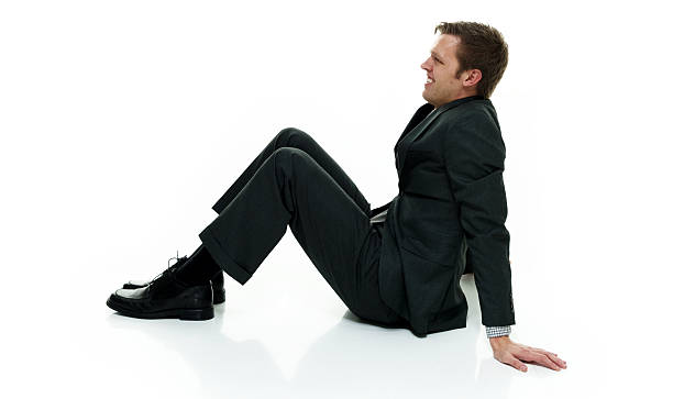 istock Smiling businessman sitting on floor 622922394