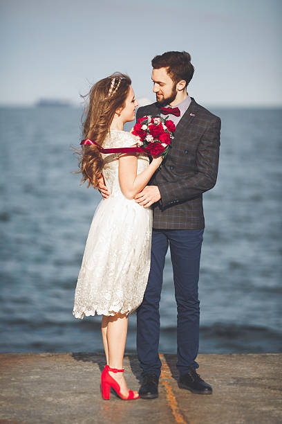 istock Just married wedding couple walking on the beach at sunset. 622923920