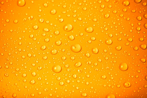 istock Drops of water on a color background. Orange 622924678
