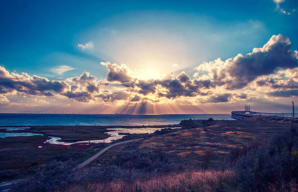 beautiful and dramatic sunset over oresunds bridge from sweden side