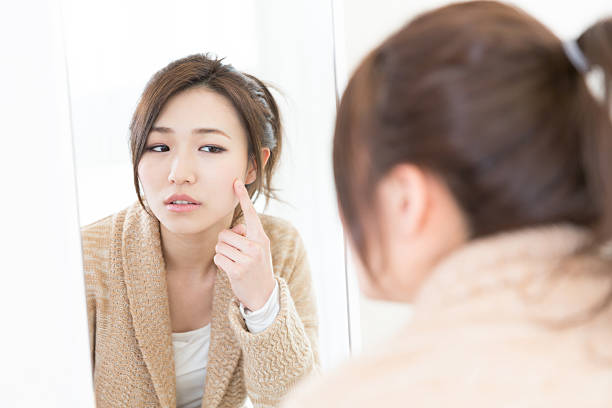 istock Woman looking in a mirror 622926916