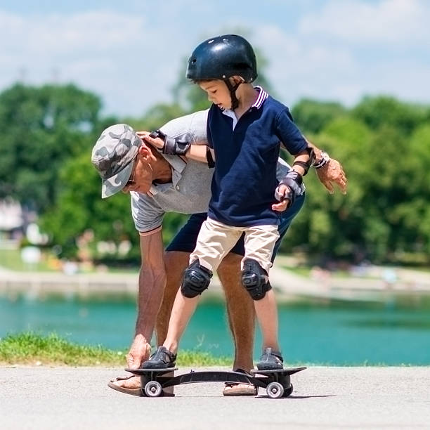 istock Learning how to ride a snakeboard by the lake 622954234