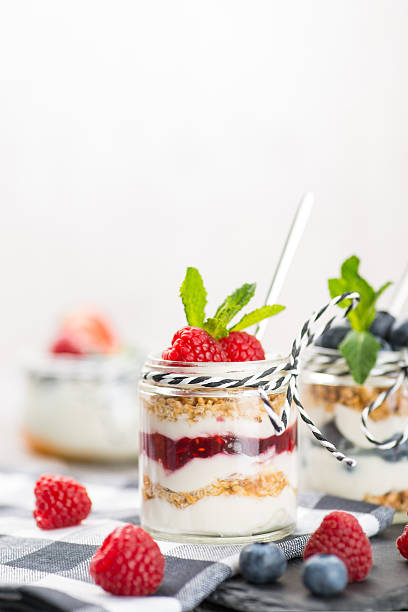 istock Jars with fresh yogurt and berries on table 622955974