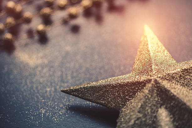 Christmas star on dark wooden background close-up.