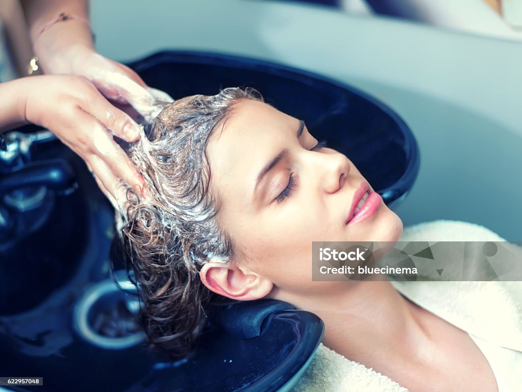 Washing Hair in Hair Salon Young woman washing hair in salon Hair Salon Stock Photo