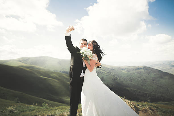 istock Beautiful young wedding couple making selfie on the background of 622957154