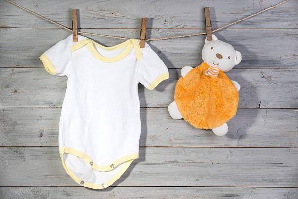 istock Baby clothes and bear toy on a clothesline 622962004
