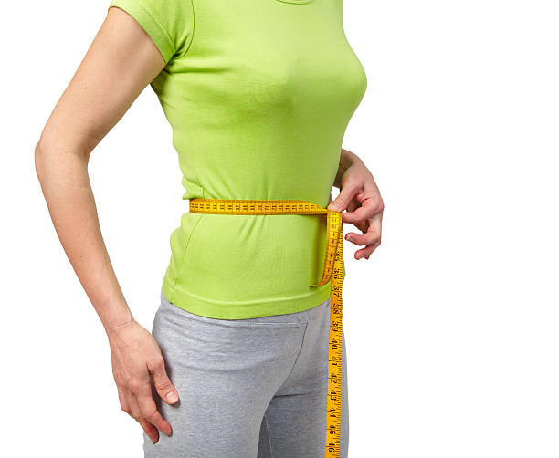 istock Slender woman measuring her waist 622964102