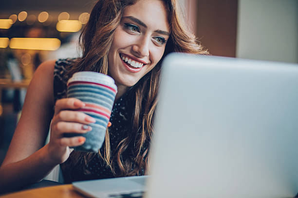 Beautiful girl with laptop and coffee cup