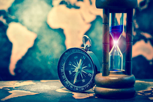 istock Compass and hourglass on grunge world map 622967044