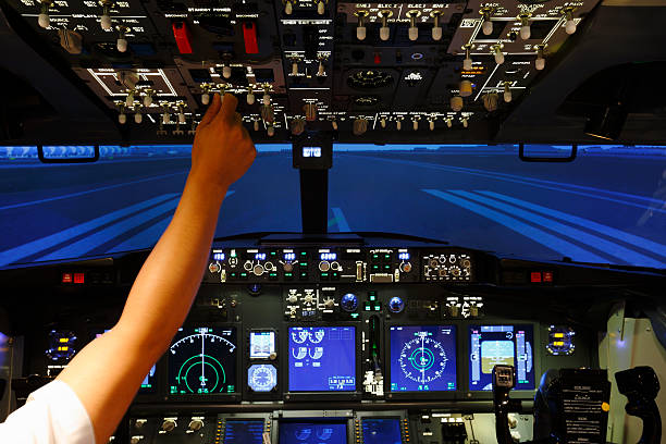 istock Hand with switch on top of cockpit in flight simulator 622968598