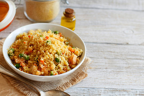 Couscous with shrimps and vegetables Couscous with shrimps and vegetables in a bowl close up couscous stock pictures, royalty-free photos & images