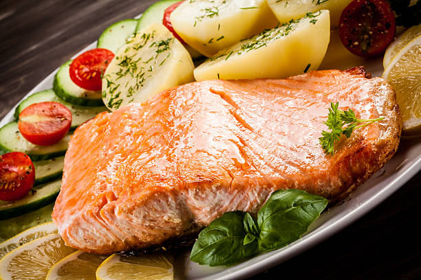istock Fried salmon, boiled potatoes and vegetable salad 622970444