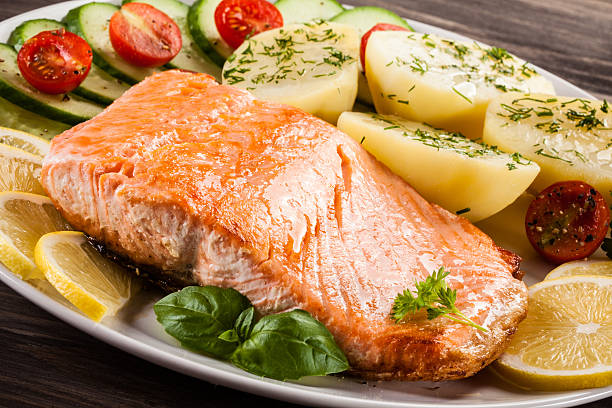 istock Fried salmon, boiled potatoes and vegetable salad 622970580