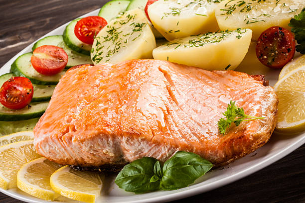 istock Fried salmon, boiled potatoes and vegetable salad 622970746
