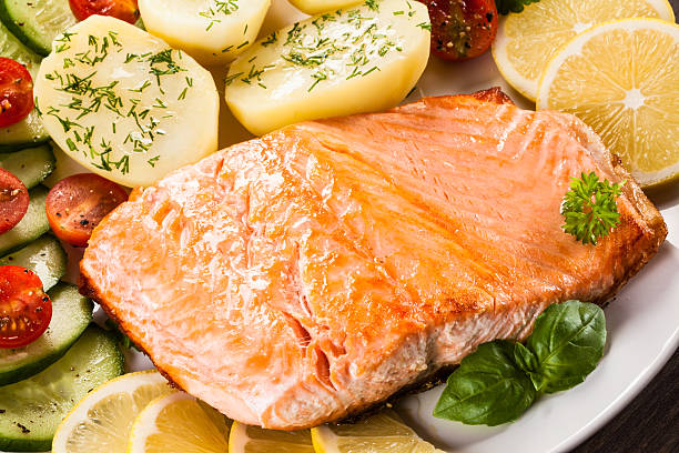 istock Fried salmon, boiled potatoes and vegetable salad 622970908