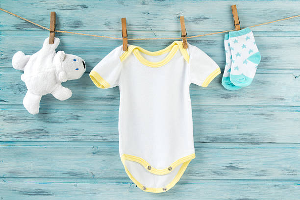 istock Baby clothes and white bear toy on a clothesline 622971780