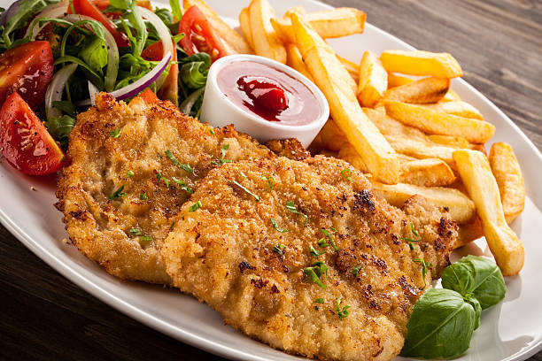 istock Fried steaks, French fries and vegetables 622971918