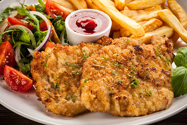 istock Fried steaks, French fries and vegetables 622972054