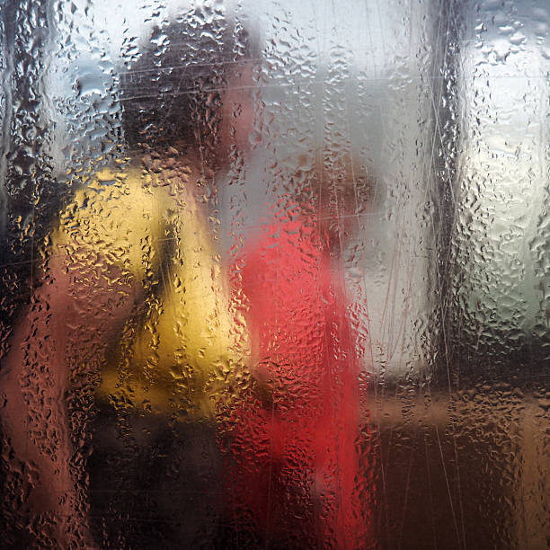 istock Two women walking behind wet glass 622972822