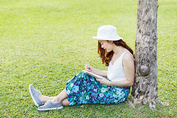 istock Beautiful asian female hands with a pen writing notebook 622975668