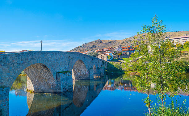 Medieval bridge over a river in sunlight stock photo