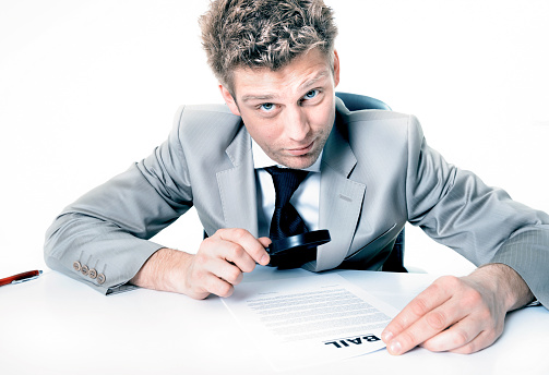 Businessman with magnifying glass study contract