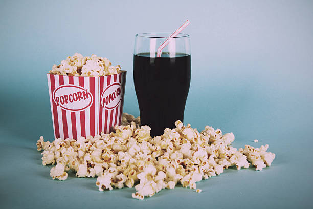 Popcorn bucket against a blue background Vintage Retro Filter. stock photo