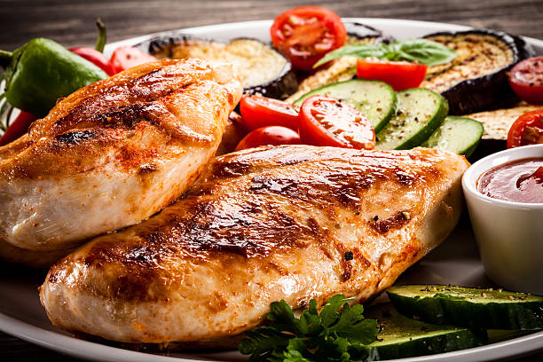 istock Fried chicken fillets and vegetables on wooden background 622981194