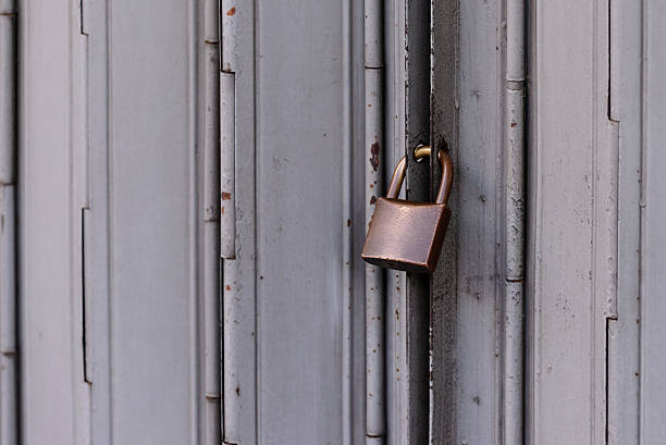 istock Locked door, grunge metal with rust doors. 622981346