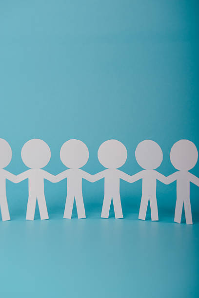 istock abstract paper people holding for hands 622981410