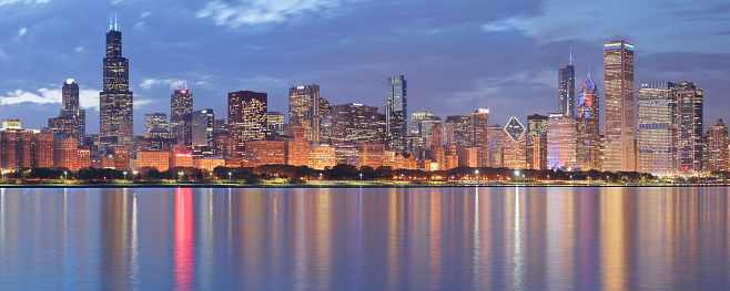 Urban skyline panorama at night (Chicago, Illinois).