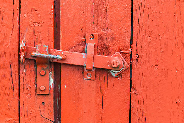 istock Old metal latch on red wooden door 622986462