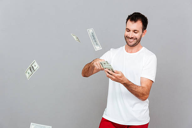 istock Handsome young casual man counting money 622987528