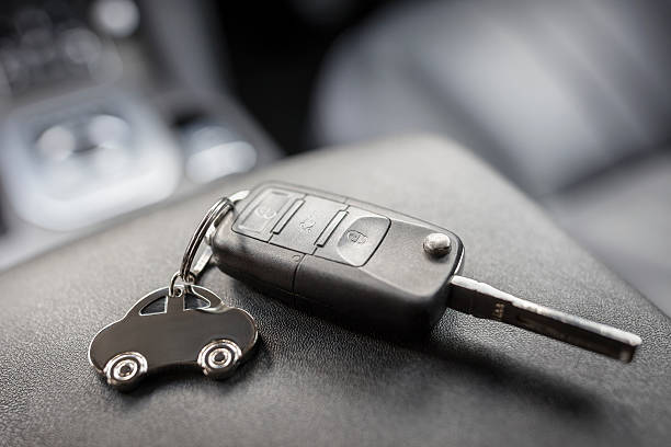Car shape keyring and remote control key Car shape keyring and remote control key in vehicle interior ignition photos stock pictures, royalty-free photos & images
