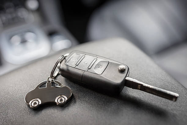 Car shape keyring and remote control key Car shape keyring and remote control key in vehicle interior key ring stock pictures, royalty-free photos & images