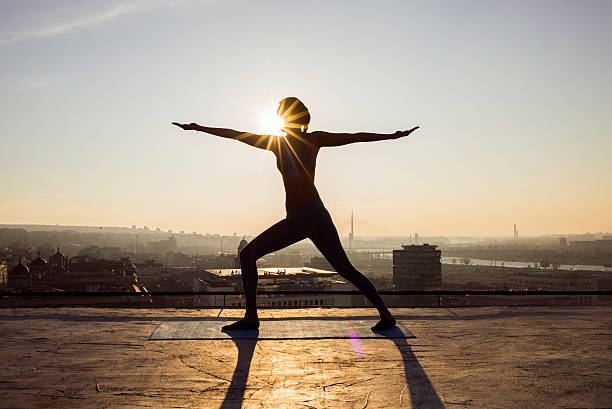 istock woman doing yoga on a rooftop 622992188