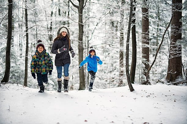 istock Happy children running in beautiful winter forest 622993324