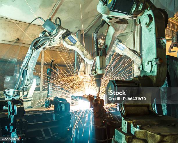 Photo libre de droit de Équipe Robot Soudage Acier Flou De Mouvement Industrie banque d'images et plus d'images libres de droit de Souder