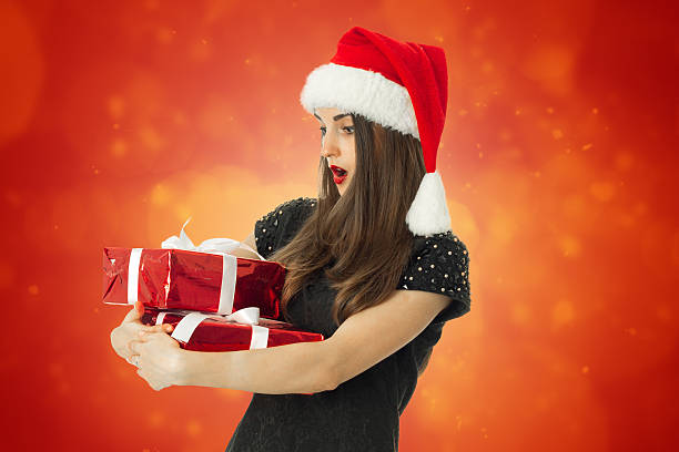 istock young woman in santa hat 622994760