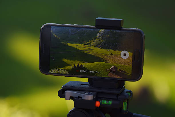 Smartphone on tripod recording timelapse in sunset mountain landscape Smartphone on tripod recording timelapse in the sunset with rural mountain landscape background cityscape videos stock pictures, royalty-free photos & images